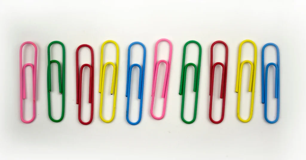 Row of colorful paper clips lined up side by side