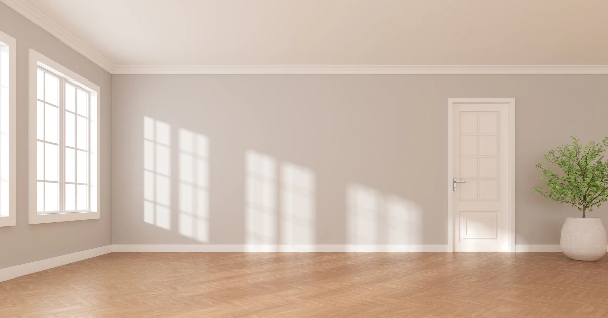 Empty room with wooden floor, large windows, and white walls