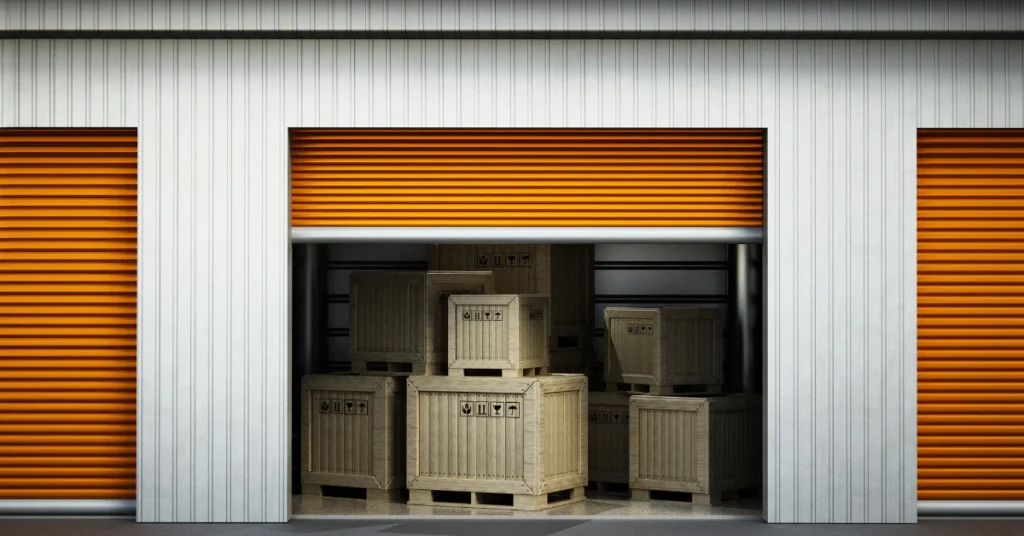 Open storage unit with orange doors and cardboard boxes stacked inside