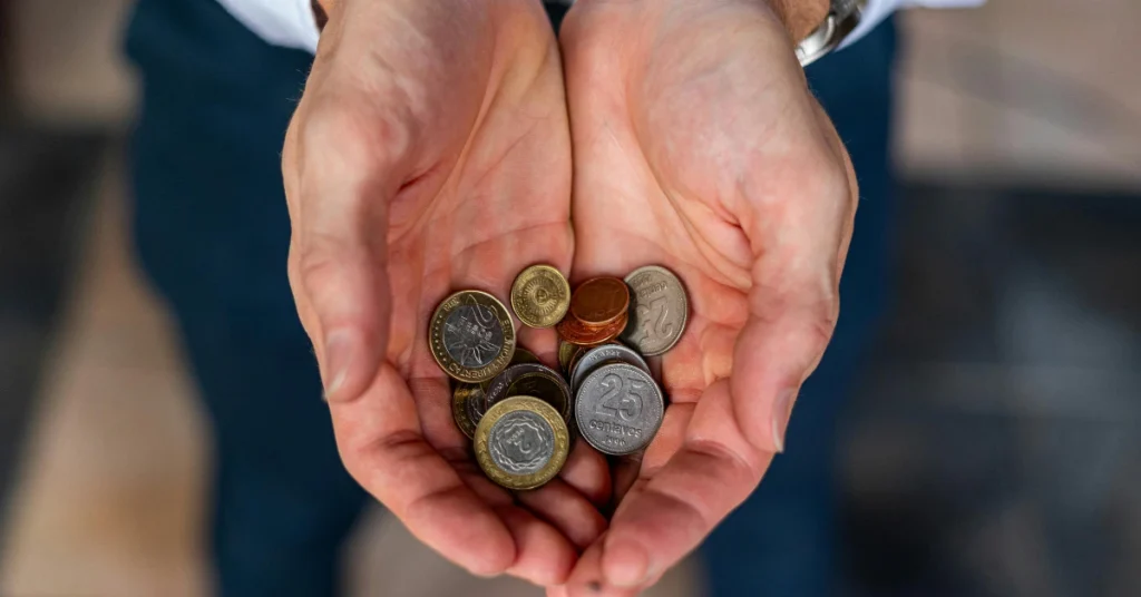Hands holding a handful of coins