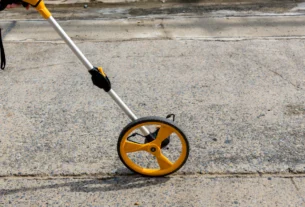 Measuring wheel on pavement used to measure distance
