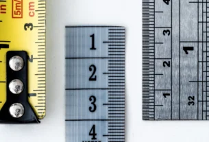 Tape measure and metal rulers showing inch and centimeter markings