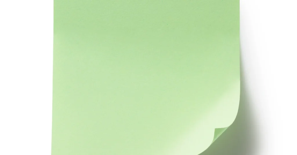 Green sticky note with a curled corner on a white background