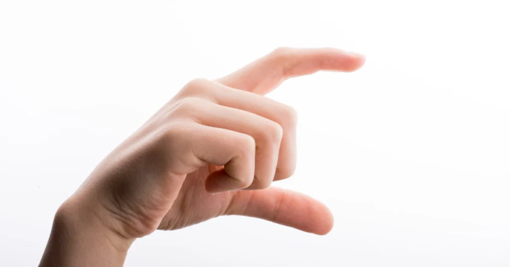 Hand held up with fingers close together to estimate a measurement without a ruler
