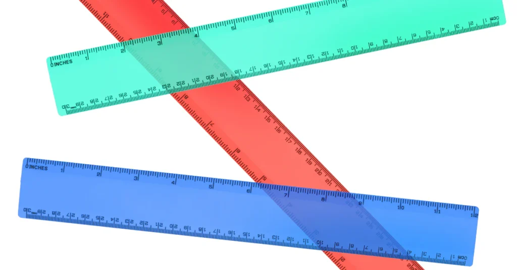 Three plastic school rulers in blue, red and green