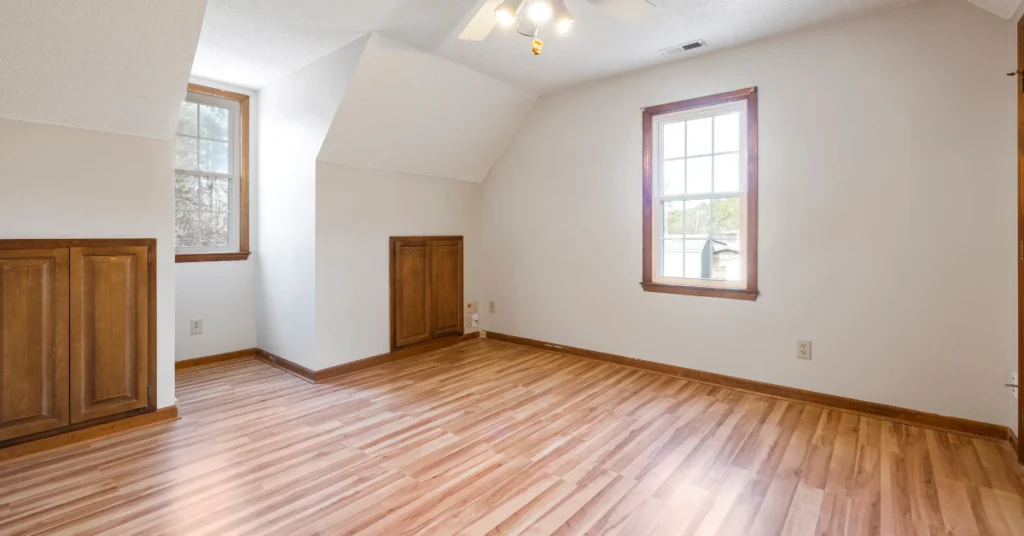 Empty room with hardwood floor and a window