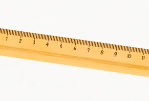 Wooden ruler lying flat, used to measure how long 9 inches is