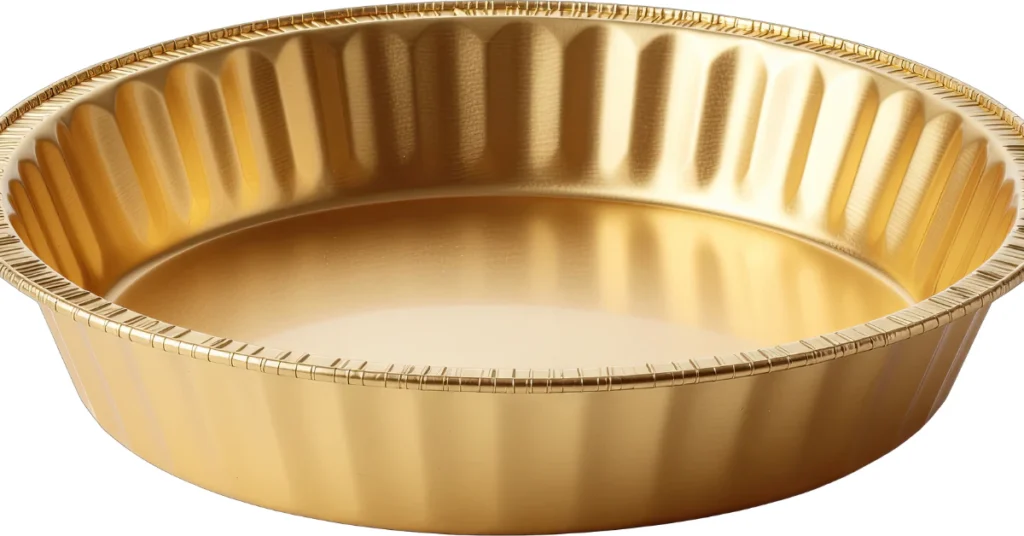 Empty golden pie pan, a common everyday object that is 9 inches across