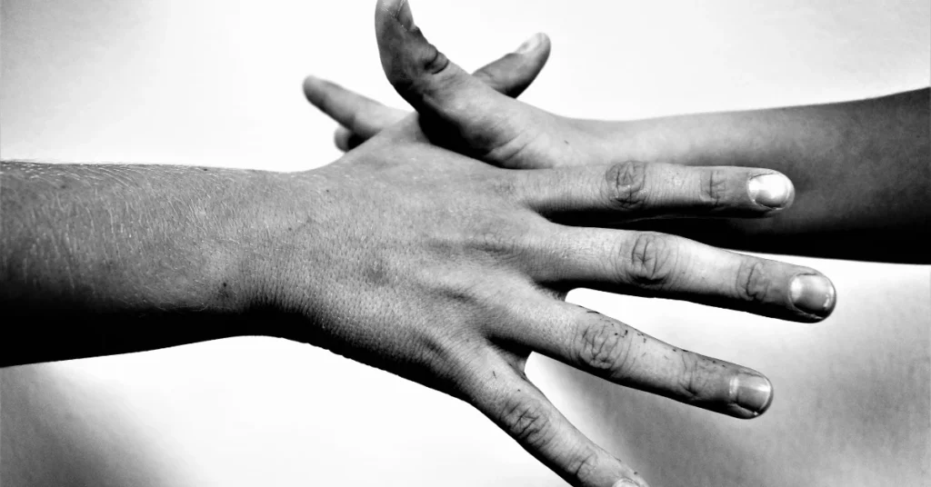 Hand stretched wide in black and white, showing the hand span trick to measure 9 inches