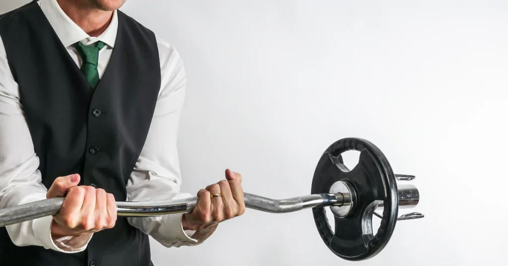 Person holding a loaded curved EZ bar with a weight plate on one end